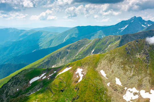 romania mountain scenery in summer. gorgeous mountainous landscape of carpathians. background with rocky cliffs and grassy hillsides under a cloudy sky. fagaras ridge of southern carpathian mountains