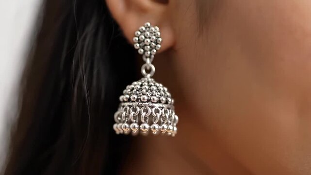 Close Up of Woman Wearing Traditional Silver Jhumka Earring with Dangling Beads