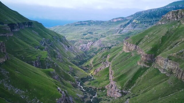 A birds eye view from a low flying drone of a gorge and abrupt slopes of the peaks on a day in summer