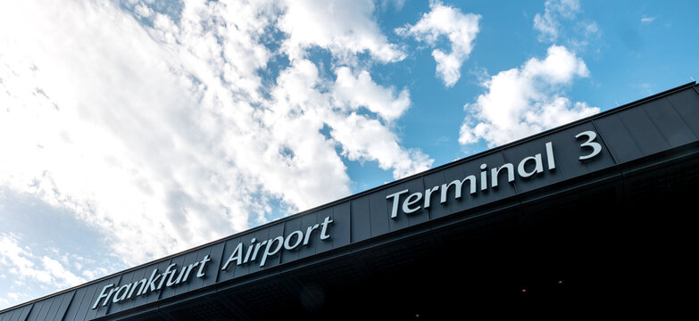 Airport Frankfurt am Main, Germany, April 11, 2026. - Frankfurt International Airport Terminal 3. View to the edge of the building&rsquo;s roof.  Blue sky with clouds in the background.
