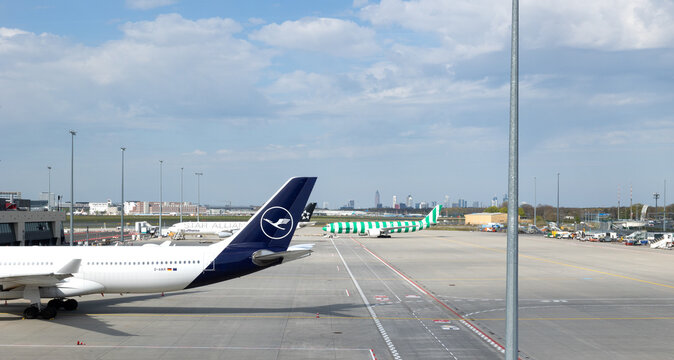 Airport Frankfurt am Main, Germany, April 11, 2026. - Lufthansa airplane on the airfield of Terminal 3. Handling area for passenger aircraft. Skyline of Frankfurt am main in the background.