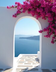 Obraz premium White archway frames deep blue Aegean Sea and distant islands. Pink bougainvillea flowers cascade over white wall, creating Mediterranean paradise view. Stone path leads towards ocean.