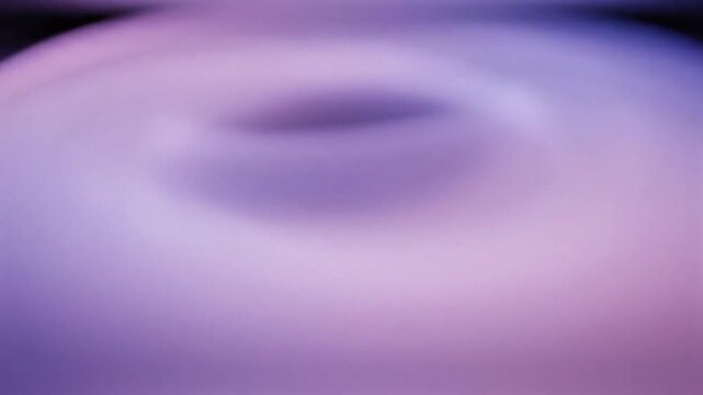 Vibrant purple swirl pattern creates mesmerizing abstract design on flat surface