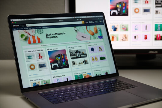 Milan, Italy - 2026, 20 Apr: Amazon logo displayed under a magnifying glass on laptop screen displaying the Amazon&rsquo;s website.