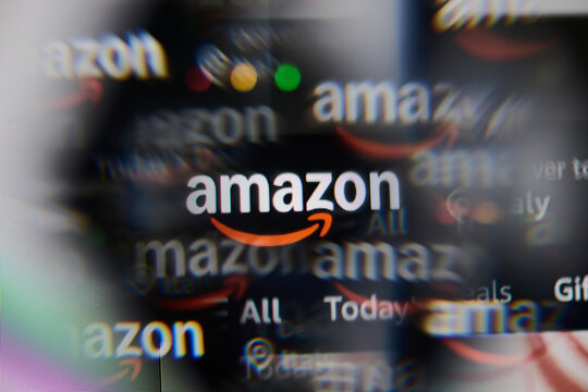 Milan, Italy - 2026, 20 Apr: Amazon logo displayed under a magnifying glass on laptop screen displaying the Amazon&rsquo;s website.
