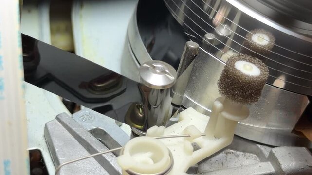 The internal gears and magnetic head of the VCR spin rapidly to read the VHS tape. This action creates a steady mechanical whirring sound and a faint, rhythmic hiss as the reels rotate.