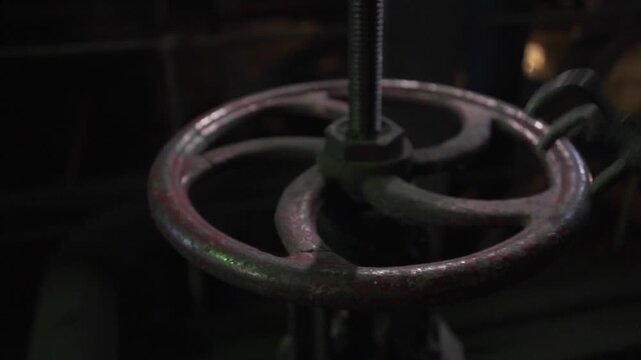 The worker tightens the valve.
