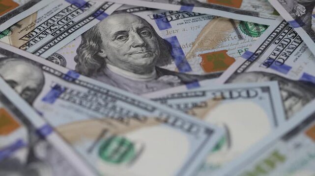 Rotating close up of hundred dollar bills background