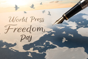 Fototapeta premium world press freedom day concept with a fountain pen and birds flying over a world map representing global journalism rights and news media information
