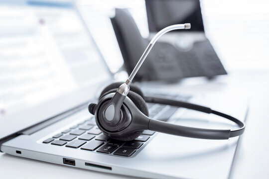 Headset headphones telephone and laptop in call center