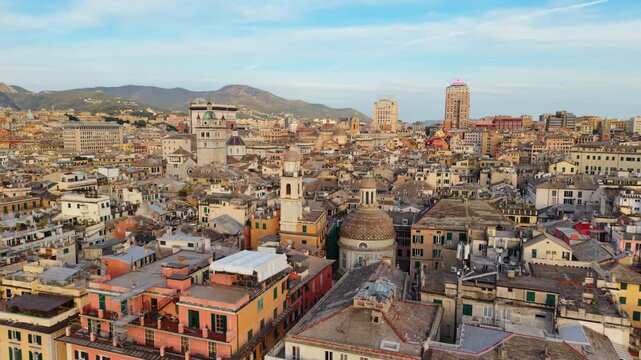 Drone aerial of Genoa historic center and Porto Antico at sunset, stunning cityscape view, Italy.