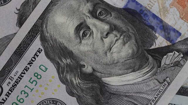 Rotating close up of hundred dollar bills background
