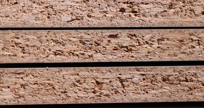 The chipboard material is stacked, a composite material made of wood with a porous edge and a multilayer structure in side lighting with a clear contour and an organic surface.