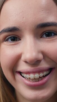 Portrait face of young woman with beautiful dark eyes look and smile into camera. Female, beauty, confident, happy, cheerful, close up. Slow motion