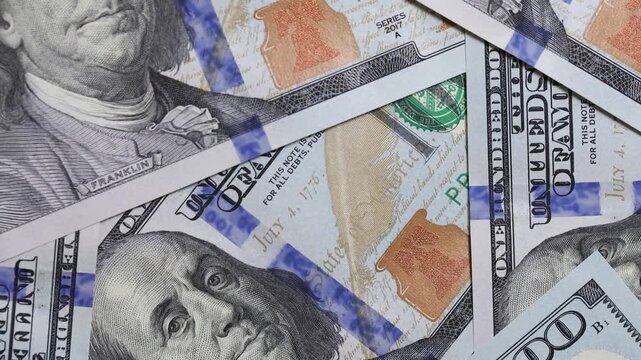 Rotating close up of hundred dollar bills background