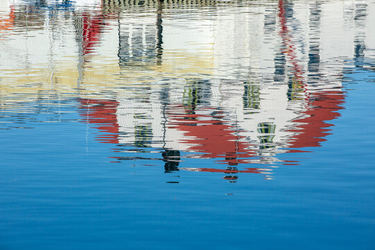 An abstract and shimmering reflection of white building on water surface in Lofoten Islands, Northern Norway