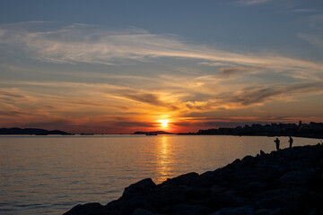 Obraz premium Istanbul Kartal Coast Sunset with Fishermen Silhouettes, Sea of Marmara and Princes Islands, Turkey