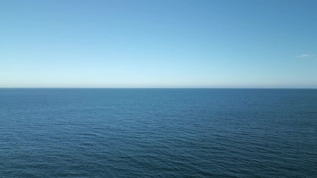 Endless blue ocean water under clear sky