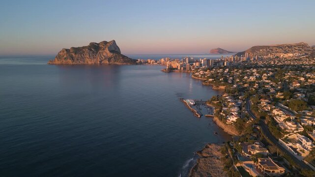Scenic aerial view of calpe's coastline and ifach rock at sunrise