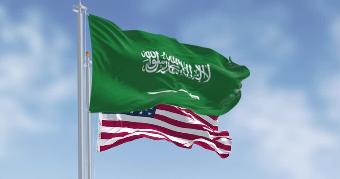 Saudi Arabia and United States flags waving side by side. Seamless 3d render animation. Slow motion loop. Selective focus