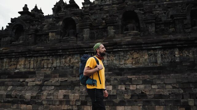 Man walking through Borobudur Temple, cinematic spiritual journey