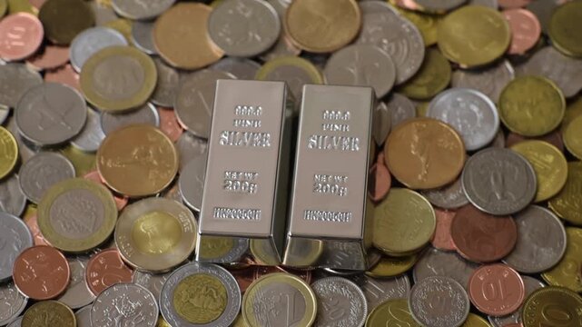 A silver bar, white metal against a backdrop of money, as a concept for the sales market. A silver bar as a background for your design