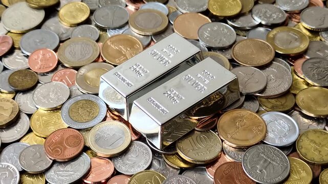 A silver bar, white metal against a backdrop of money, as a concept for the sales market. A silver bar as a background for your design