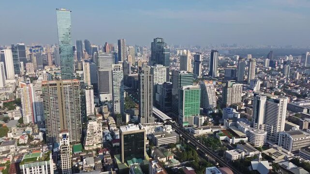 Aerial high view of Bangkok city, urban skyscrapers and office buildings in business district, Thailand, 4k
