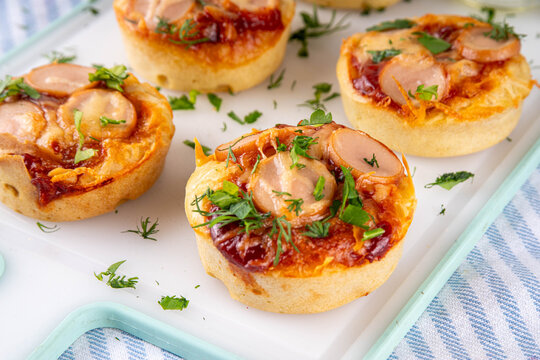 Chicago style pizza bites, Portioned Deep Dish Pizza Cupcakes, pizza muffins with tomato sauce, a lot of cheese, ham sausages