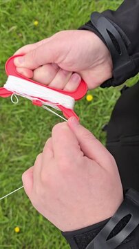 First-person winding kite string, hands only