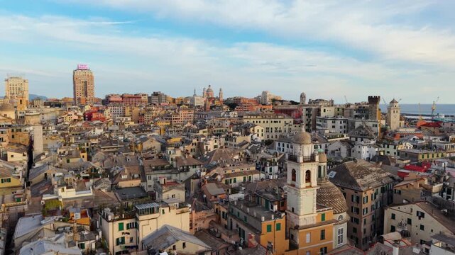Cinematic drone push over Genoa&rsquo;s historic center and Porto Antico at sunset, flying over colorful buildings, stunning architecture of Italy.