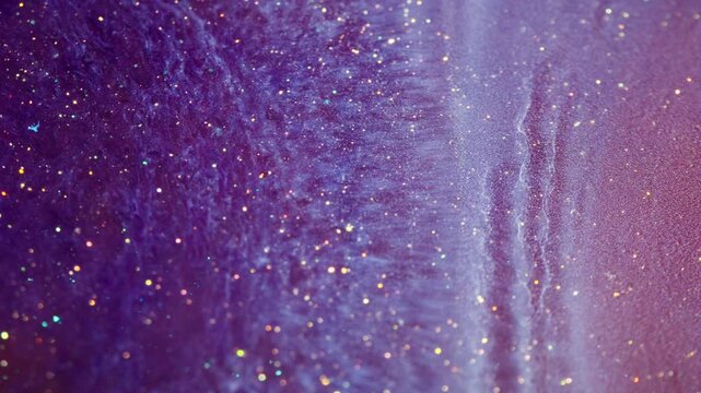 Abstract purple fluid with gold glitter sparkling in macro photography