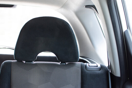 Car Back Seat Headrest, A close-up of a modern, adjustable car headrest on the back seat, focusing on automotive comfort.