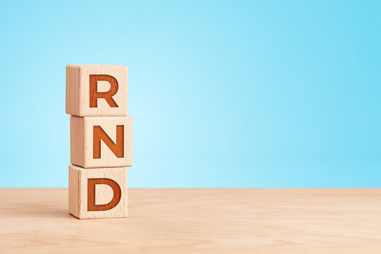 Research and development concept with wooden cubes on blue background
