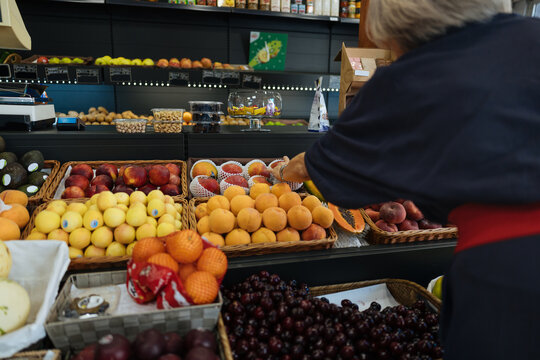 Shopper selecting fresh fruit at a local greengrocery market