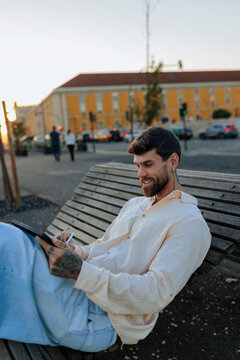 Man drawing on digital tablet outdoors creative work