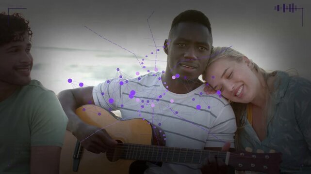 Guitarist strumming beachside causing purple overlay camera zooming woman leaning making music mood