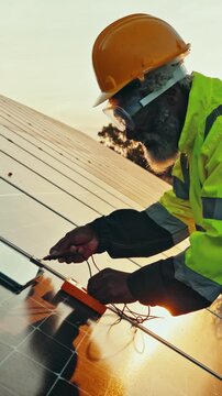 Tablet, solar panels and technician on rooftop with repairs, maintenance or sustainability project. Renewable energy, planning and African male electrician with tech for research on installation.