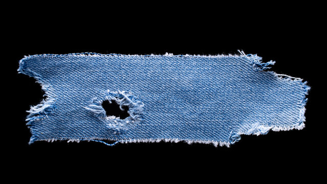 jeans. a frayed and torn piece of denim rag.