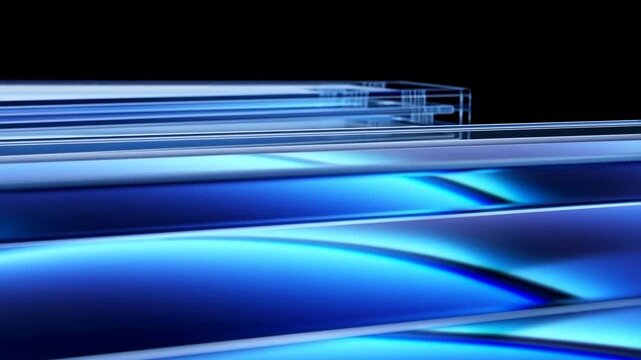 Tracking shot of layered glass panels sliding across glossy blue reflective surface on black studio background with shallow depth of field
