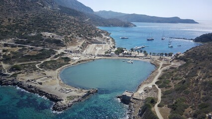 Obraz premium Aerial drone view of Knidos Ancient City in Datça, surrounded by deep blue and turquoise shades of the Aegean Sea, ancient ruins on a dramatic peninsula, crystal-clear water, cinematic wide angle, ser