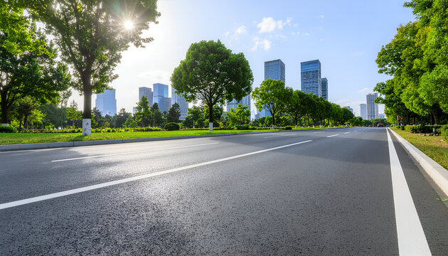 Empty urban boulevard with skyline and trees in bright sunlight.