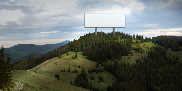 Billboard mockup on forest mountain ridge for outdoor advertising presentation. Concept of brand visibility, copy space layout, marketing strategy and campaign showcase.