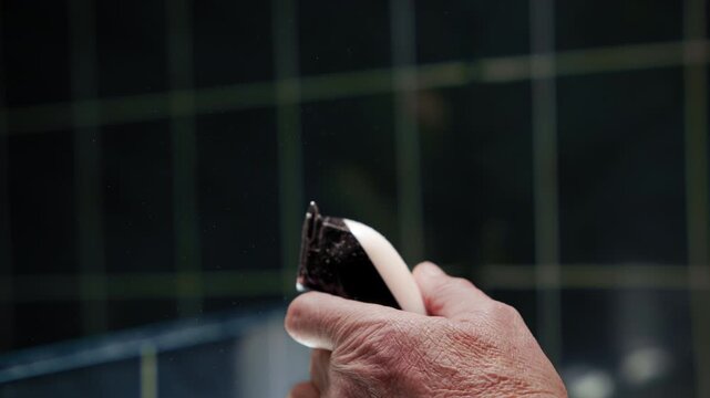The man cleaned the dirt off the trimmer and attached the hair attachment to it