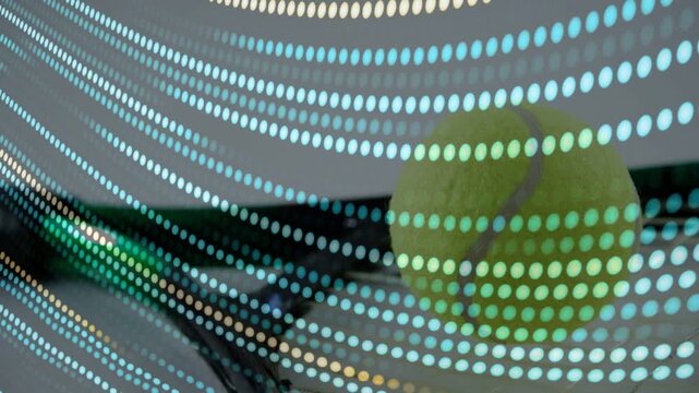 Camera panning, tennis ball emerging behind dot panel, dots shifting, revealing racket