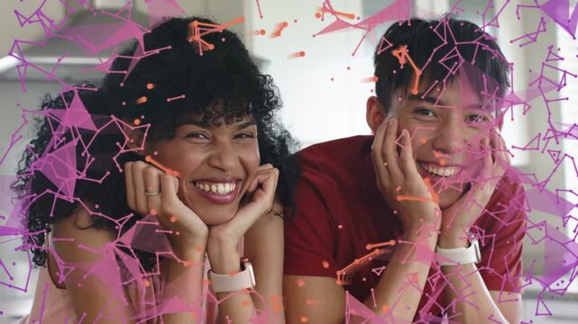 Couple leaning on counter, particle overlay appearing over faces and showing watches for marketing