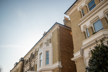 Fototapeta premium LONDON - Low angle view of elegant Victorian terraced houses in Earls Court with blue sky copy space