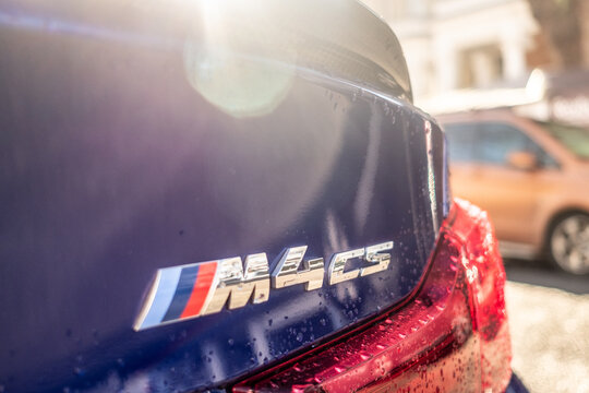 LONDON - Close-up of BMW M4 CS badge on wet car with raindrops