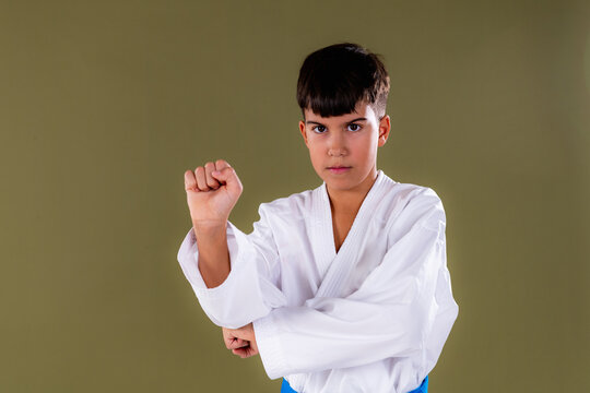 A focused karate student performs a front punch, oi zuki,  with strong posture and precise execution.