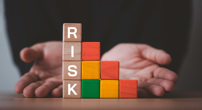 Risk management concept with stacked blocks showing risk levels from low to high, symbolizing business uncertainty, assessment, mitigation strategy and protection planning for sustainable growth